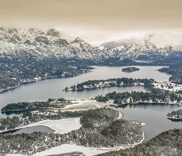 Vista of snow covered mountains and lake in Argentina