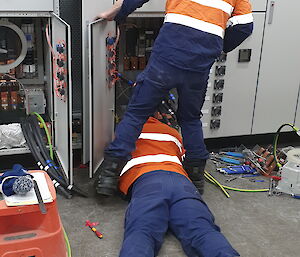 Two electricians working on a switchboard
