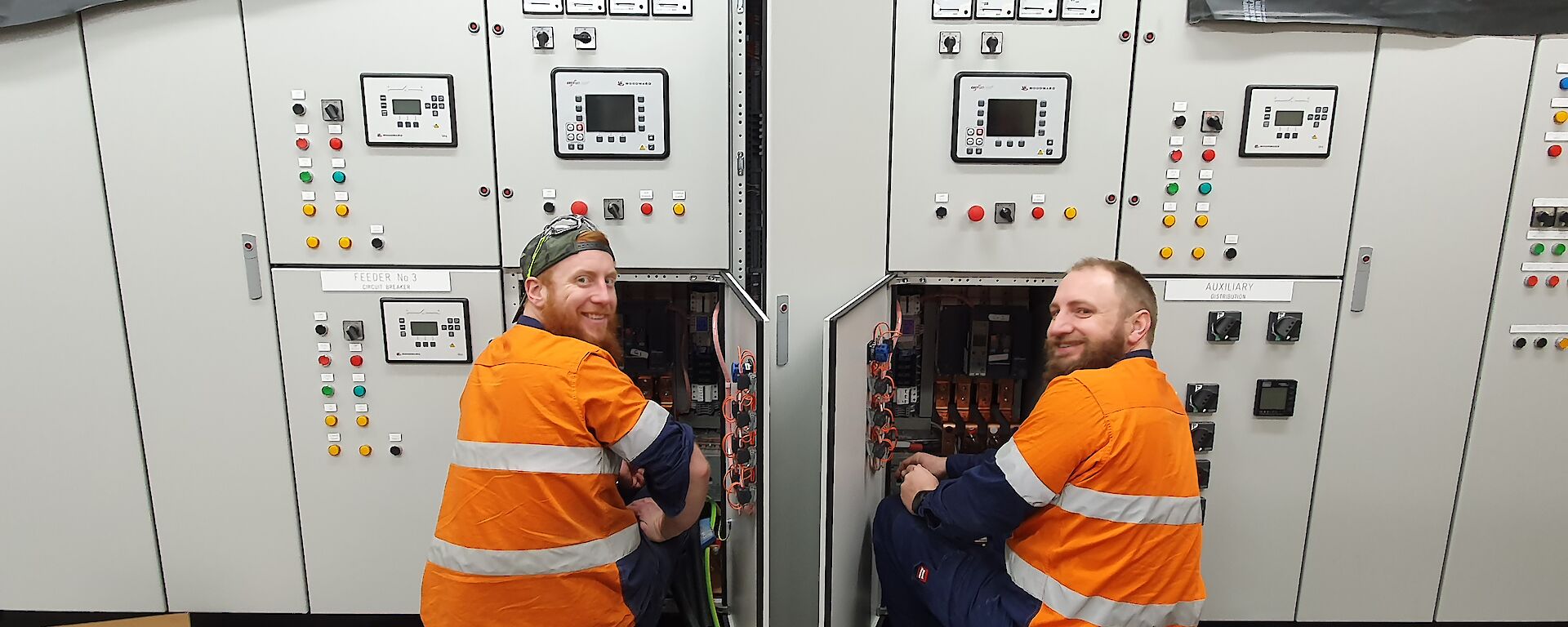 Two electricians working on a switchboard