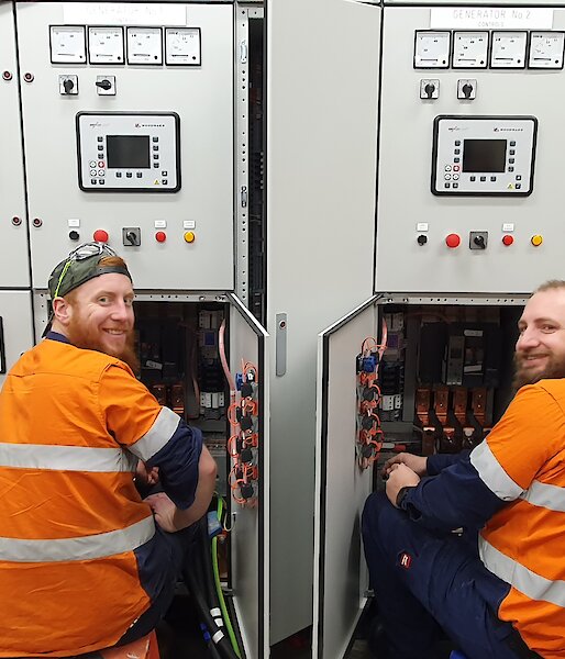Two electricians working on a switchboard