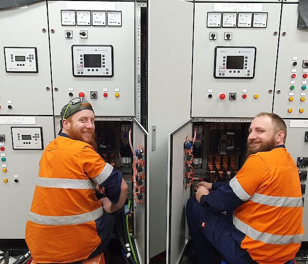 Two electricians working on a switchboard