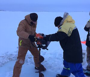 Drilling a hole in sea ice with a drill