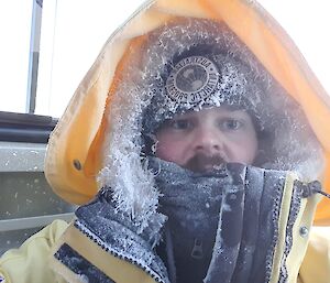 Nathan Earl in winter gear covered in frosty ice