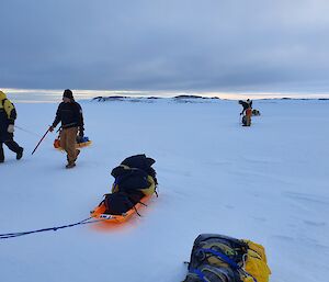 Walking across the sea ice hauling sleds to Wilkes station