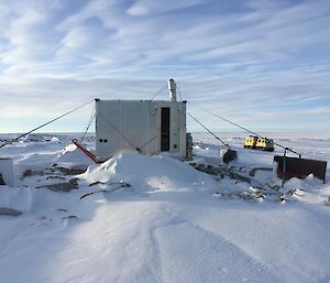 A field hut surrounded by snow