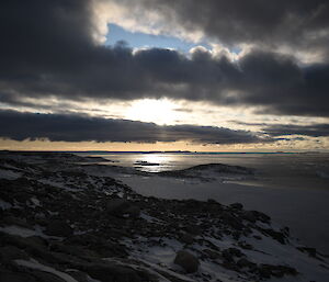 A constrasting sky with blue showing through and dark but light rimmed clouds looking towards the mouth of Newcomb Bay