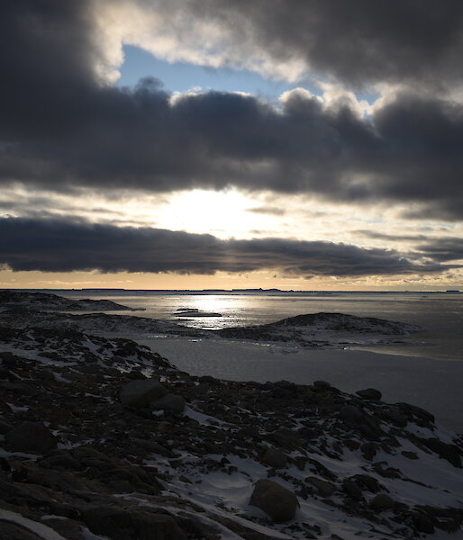 A constrasting sky with blue showing through and dark but light rimmed clouds looking towards the mouth of Newcomb Bay