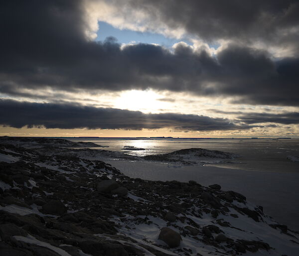 A constrasting sky with blue showing through and dark but light rimmed clouds looking towards the mouth of Newcomb Bay