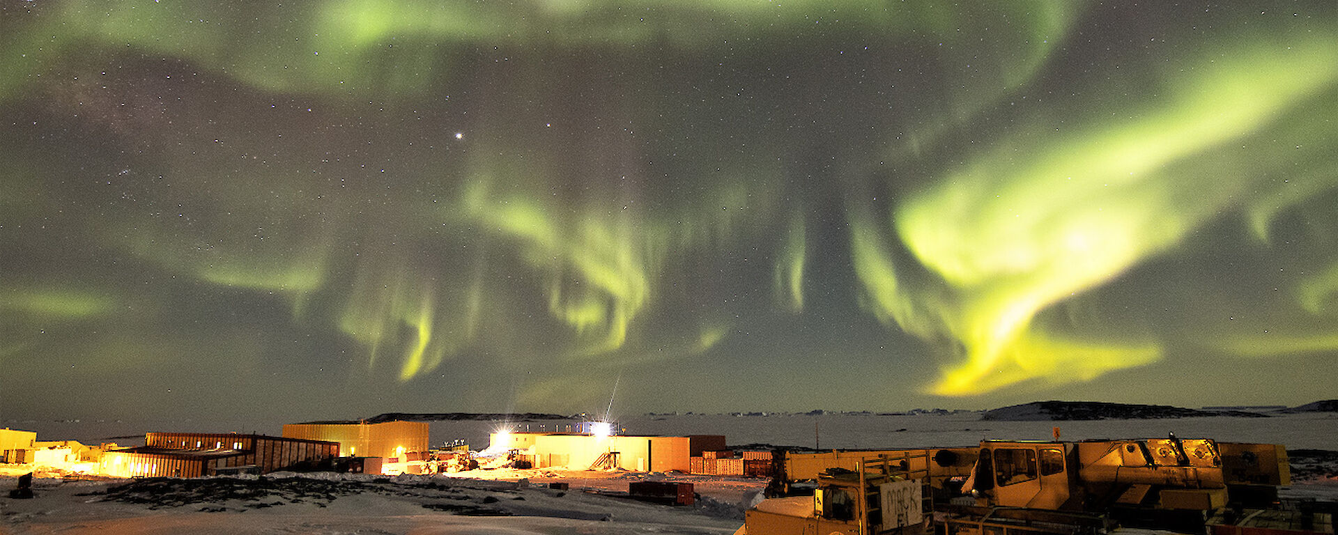 Aurora at night over station buildings