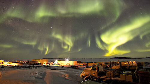 Aurora at night over station buildings