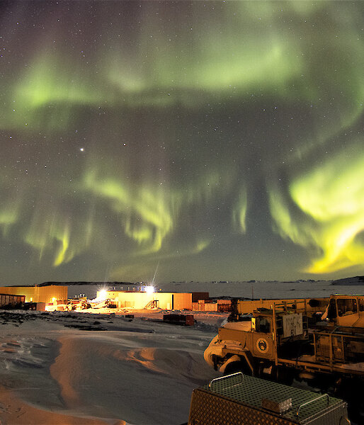 Aurora at night over station buildings