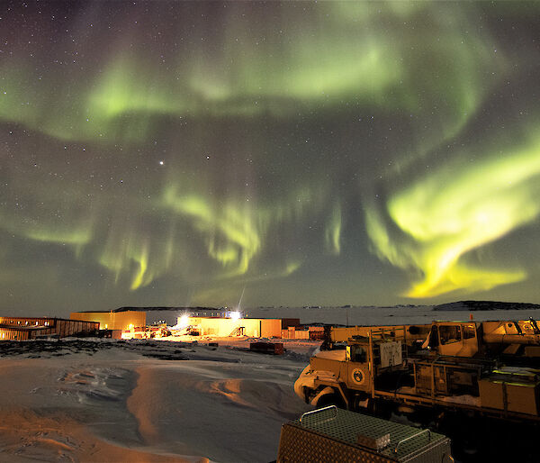 Aurora at night over station buildings