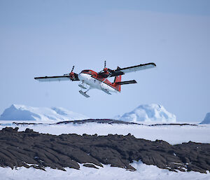 plane over rocky and icy landscape