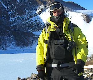 Expeditioner in foreground with frozen moustache.  A mountain and frozen lake in background