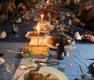 A shot of all expeditioners sitting at the dining table with lots of food