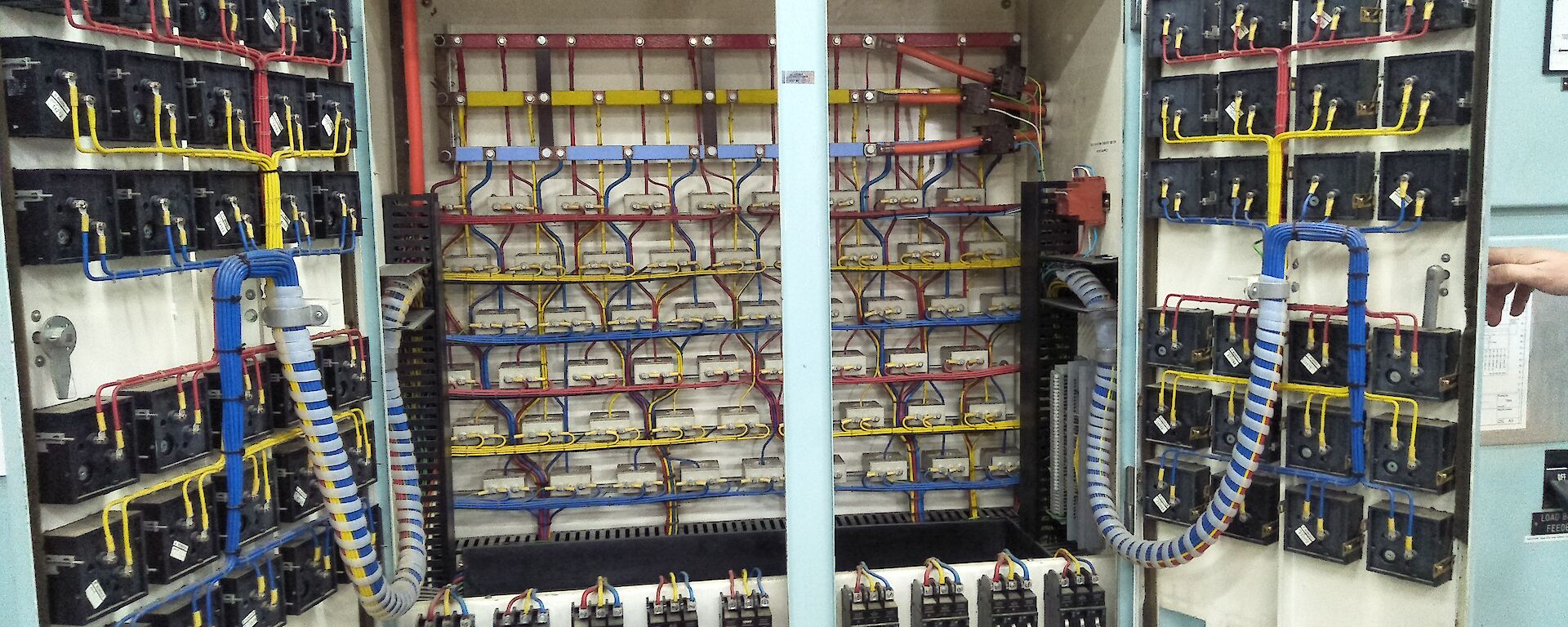 A large electrical switchboard with lots of wires