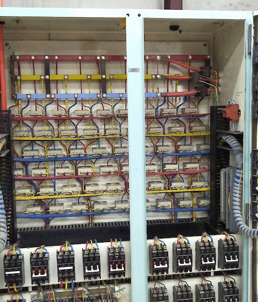 A large electrical switchboard with lots of wires