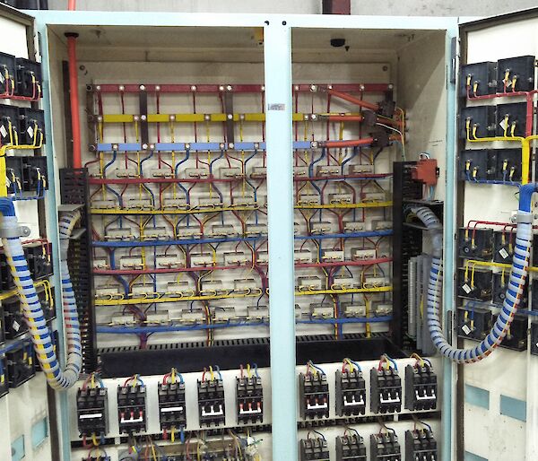 A large electrical switchboard with lots of wires