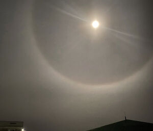 Halo of light around the moon above station