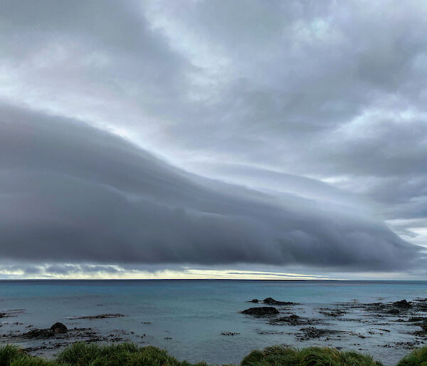 Roll of dark moody cloud over the ocean