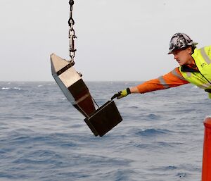 man with sampling equipment on ship