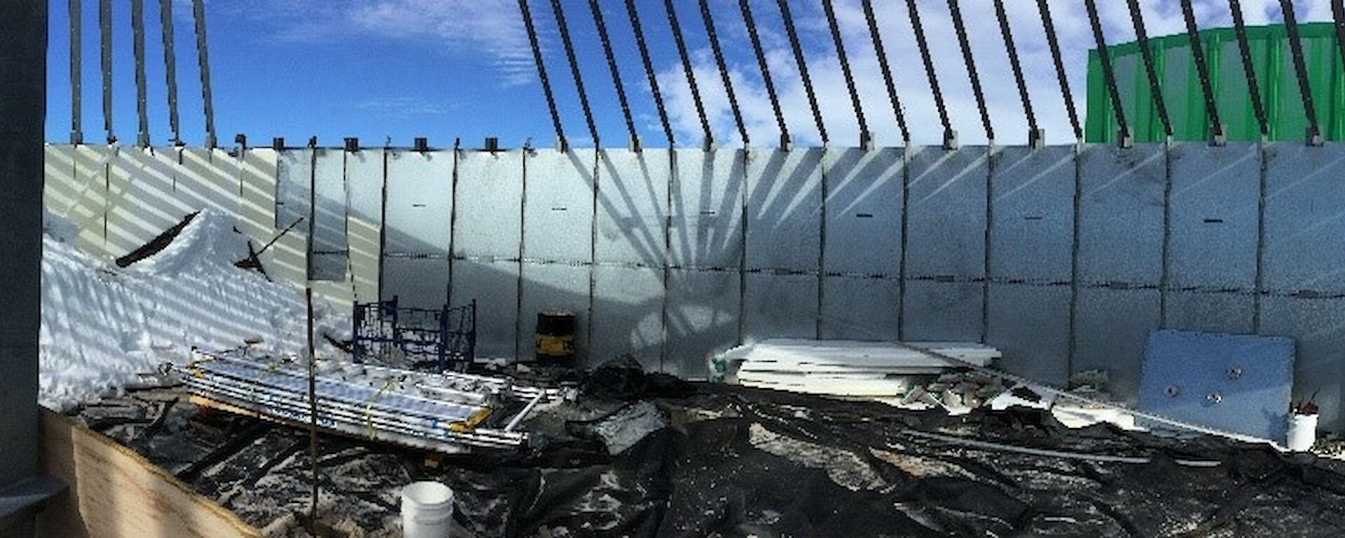 Inside a large container with no roof, full of debris
