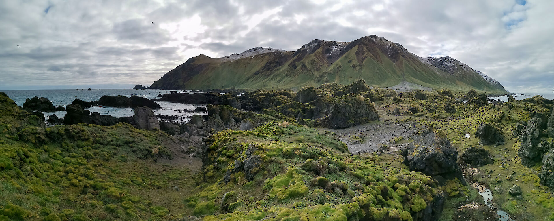 A panoramic shot showing the rise of the island and some beautiful rocky landscapes