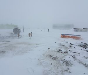 Men walking in a blizzard.
