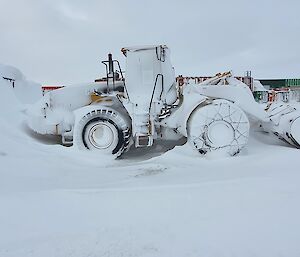 A loader covered in snow