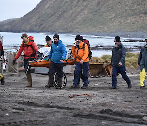 The team conducting a stretcher carry though the station