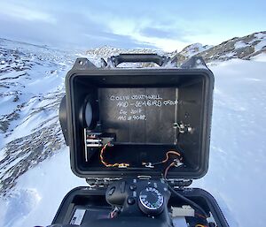 The back of a camera case indicating its one of Colin Southwell's monitoring a penguin colony near Casey