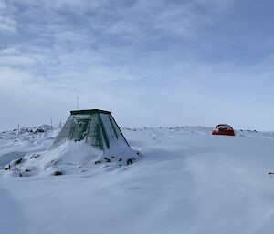 Two snow covered shelters