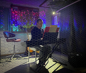 Man sitting at keyboards playing music