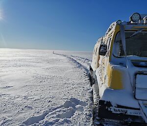 The yellow Hagg heading for Brownings in deep snow leaving tracks behind it