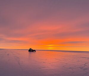 Proof roller on the Wilkins runway as the day dawns with brilliant sunrise colours