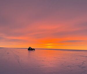 Proof roller on the Wilkins runway as the day dawns with brilliant sunrise colours