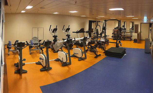 Exercise bikes and weigh lifting equipment in the Nuyina's gym.