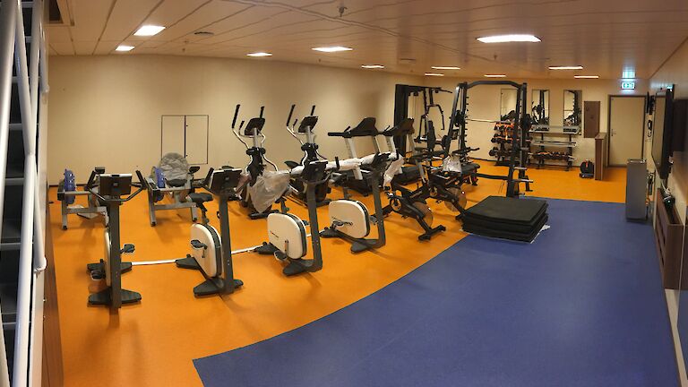 Exercise bikes and weigh lifting equipment in the Nuyina's gym.