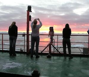 Expeditioners viewing a sunset