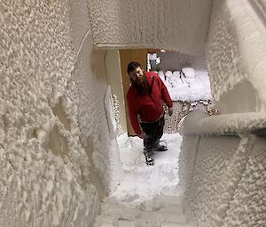 A man stands in a frozen stairwell at Wilkins Aerodrome