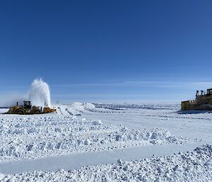 Tractors and heavy snow moving machinery sit on the ice at the Wilkins Aerodrome