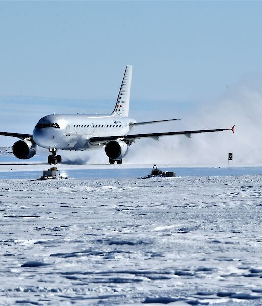 jet plane lands in plume of snow and ice