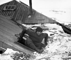 Man climbs out of a hut in Antarctica