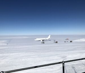 The A319 on the runway at Wilkins Aerodrome with support vehicles parked next to it