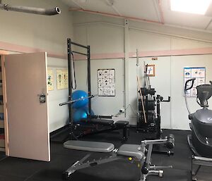 The station gymnasium showing the bench press machine, exercise bike and a bench