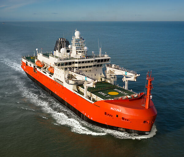 A red, white and black ice breaking ship