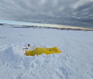 Yellow bivouac bag in the snow.