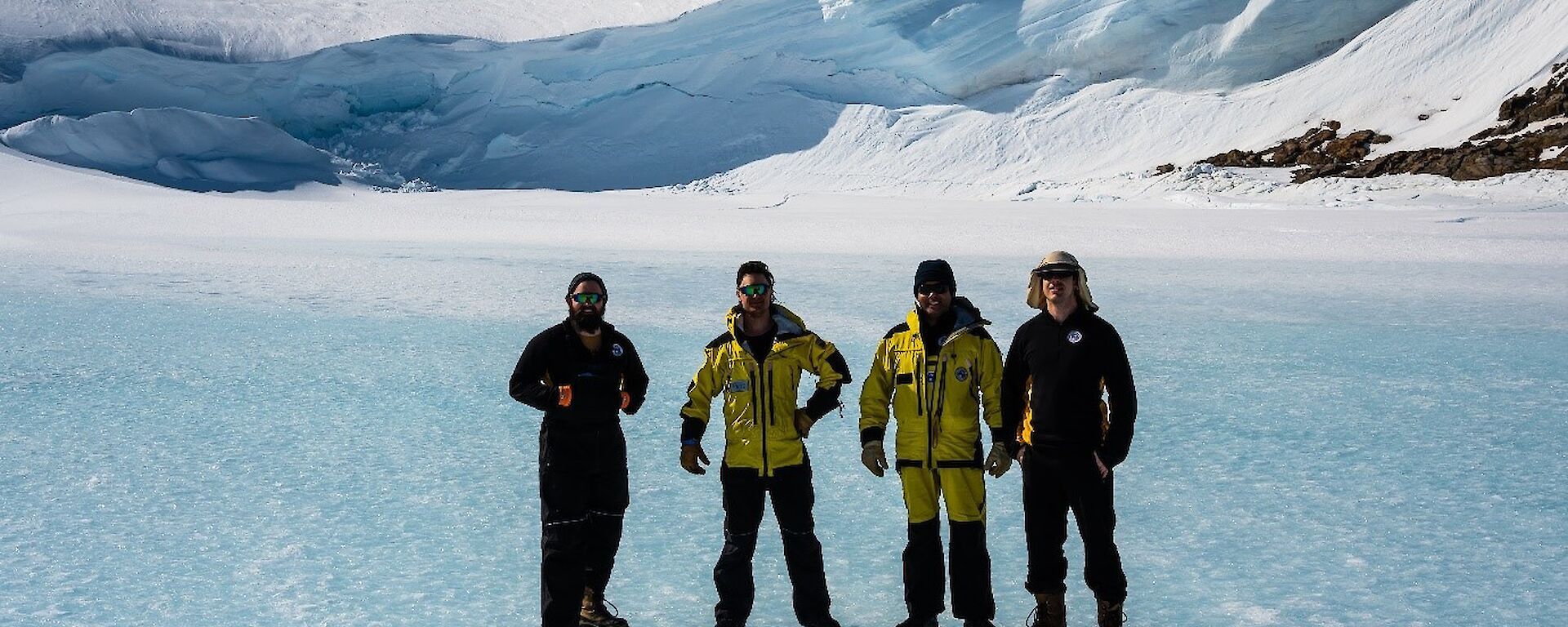 A crew of expeditioners standing on the sea ice