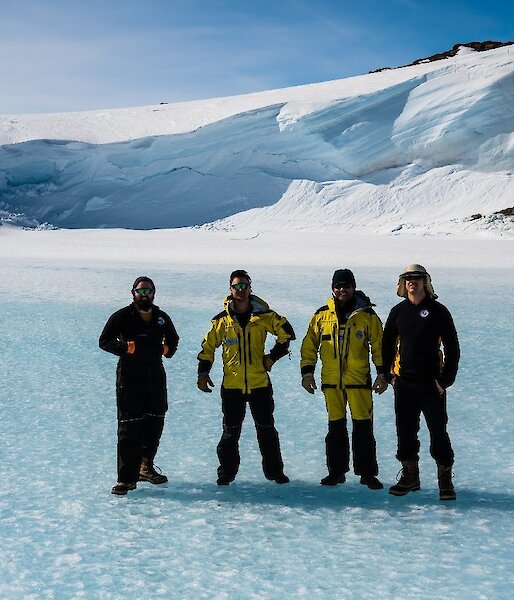 A crew of expeditioners standing on the sea ice