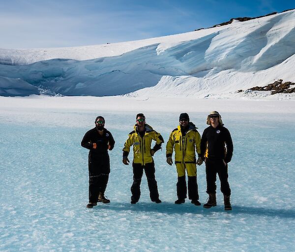 A crew of expeditioners standing on the sea ice